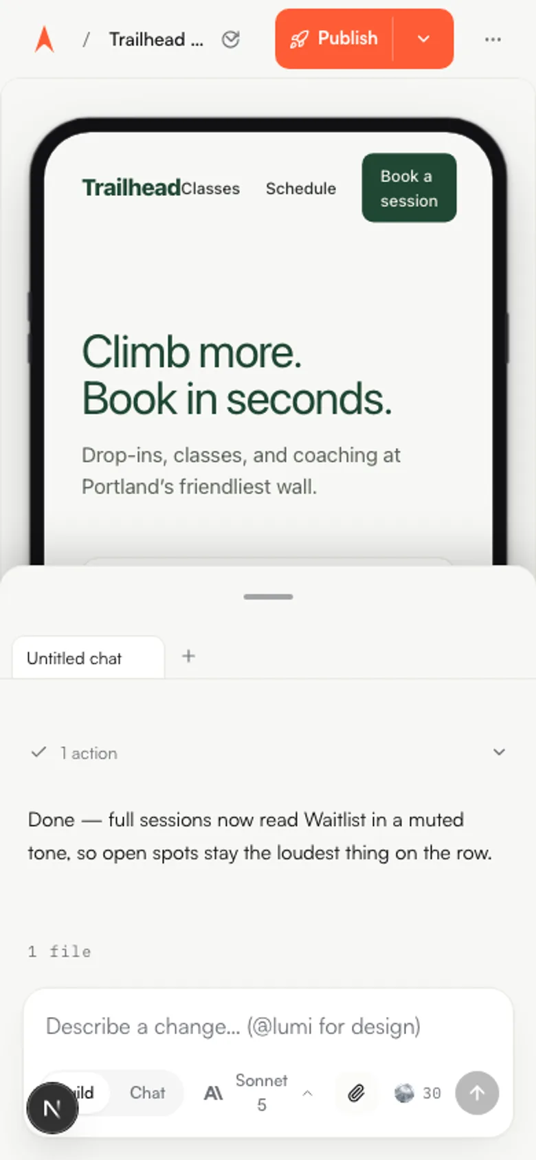 The mobile workspace: a built app in a phone frame with the chat sheet peeking from the bottom